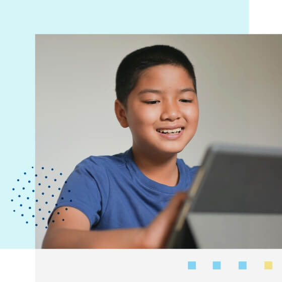 happy boy using his Ipad