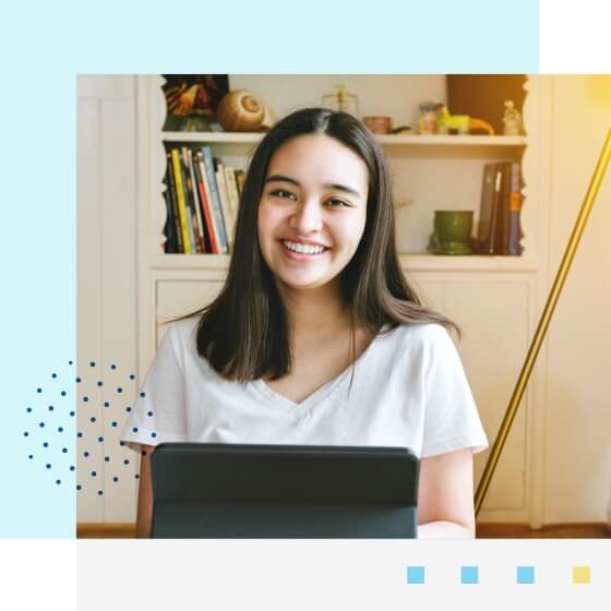 Student smiling and working on her tablet