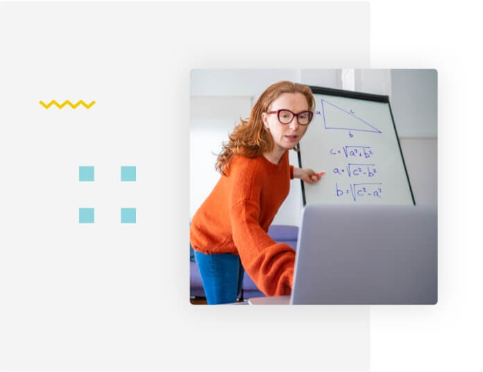 Teacher pointing to a chalkboard